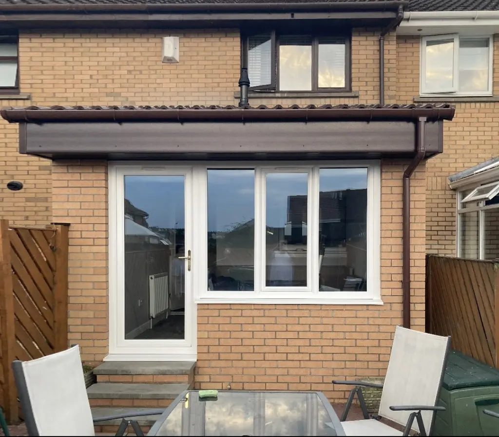 brown brick house extention with white upvc windows and doors