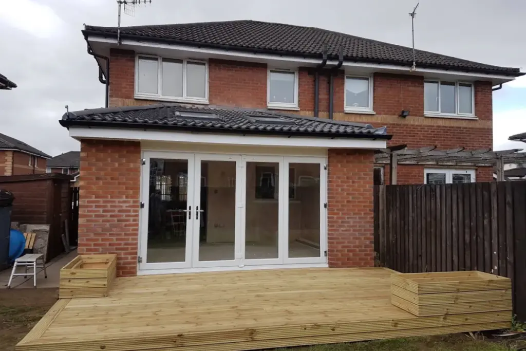 home extention of red brick house with wooden terrace